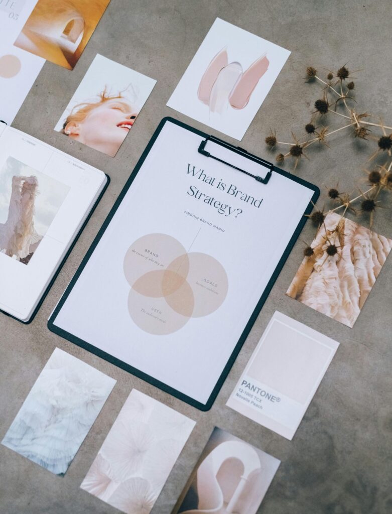 Aesthetic flat lay of branding and design documents on textured surface.